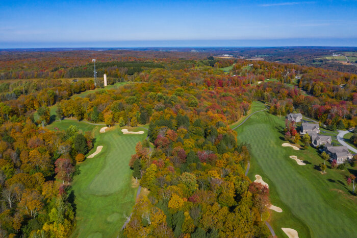 Aerial view of Peek'n Peak Resort Upper Course Golf with fall foliage