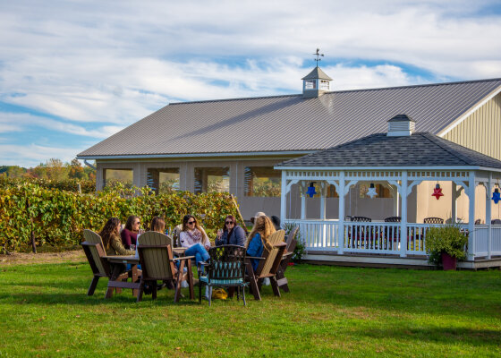 Friends tasting wine outdoors at Liberty Vineyards