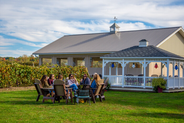 Friends tasting wine outdoors at Liberty Vineyards