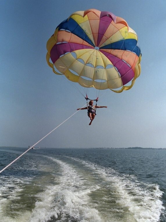 Water skier flying through the air after being dragged by a boat.