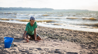 Boy playing in Hanover Beach sand 2019