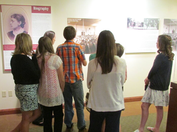 A group of people touring exhibits at the Robert H. Jackson Center in Jamestown, NY