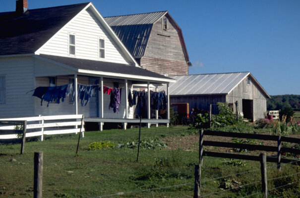 Farm house with clothes drying on the front porch.