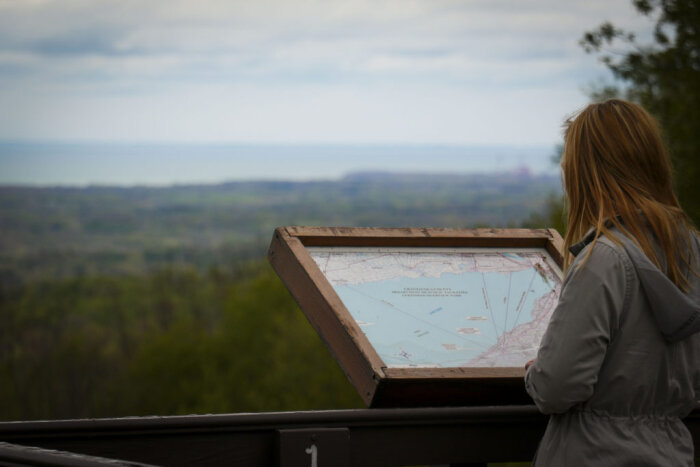 Woman viewing the map at Luensman Overlook.