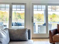 Blue Canoe Lake Cottage living room looking out on deck and Cassadaga Lakes