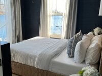 Blue Canoe Lake Cottage bedroom with queen bed lakeview