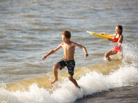 Boy and Girl jumping in water at Hanover Beach 2019