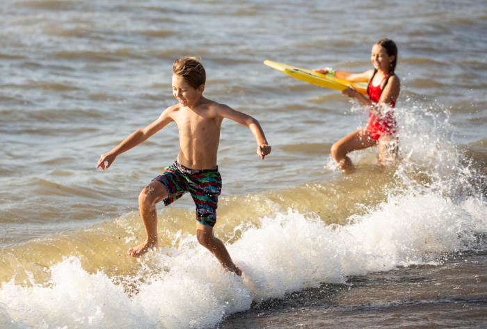 Boy and girl playing on the beach at Lake Erie, Hanover, NY