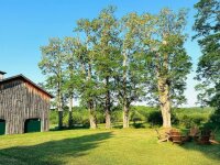 The Plum Bush Apartment exterior Adirondack chairs with barn