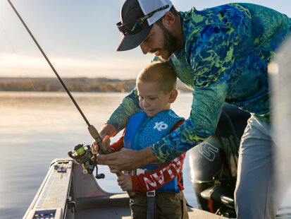 Man and boy fishing on boat on Chautauqua Lake