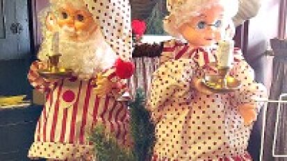 Two dolls dressed in candy stripes.