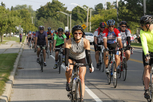 Chautauqua Gran Fondo pack of cyclists smiling woman