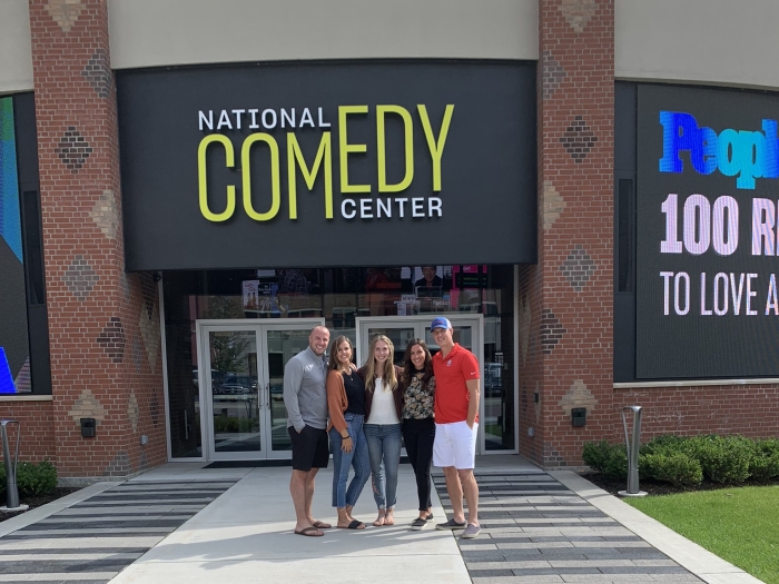 A group of friends pose outside the National Comedy Center