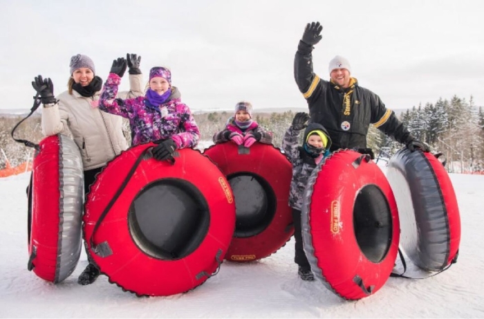 A group of friends snow tubing at Peek'n Peak Resort