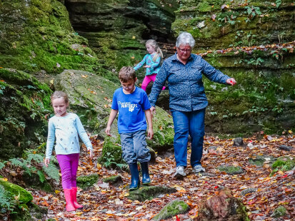 Three children on a hiking trail with their grandmother