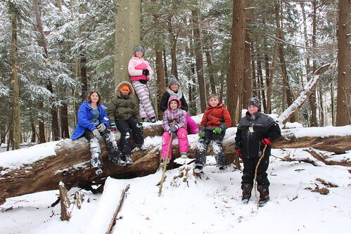 January Camp children in snowy woods at Audubon Community Nature Center