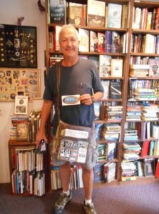 Man standing in the Novel Destinations Bookstore in Jamestown.