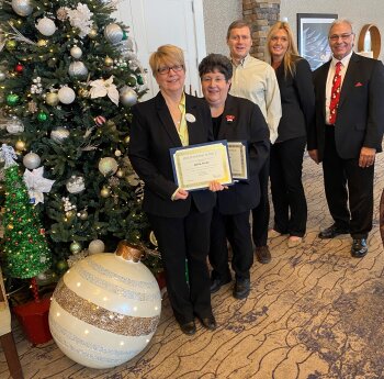 Anna Fales and Toni Bellitto Chautauqua Harbor Hotel group by Christmas Tree