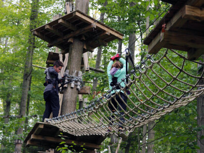 A boy and girl at Peek'n Peak Resort's Aerial Adventure Course