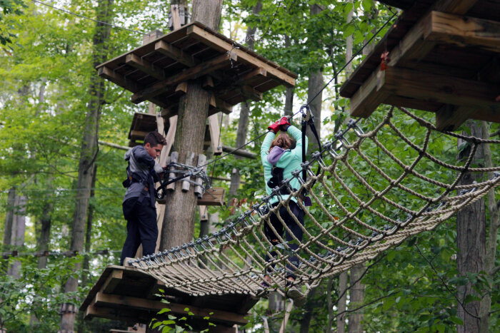 A boy and girl at Peek'n Peak Resort's Aerial Adventure Course