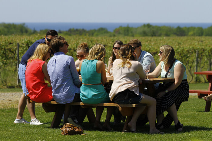 Wine tasting outside at 21 Brix Winery with Lake Erie visible in the background