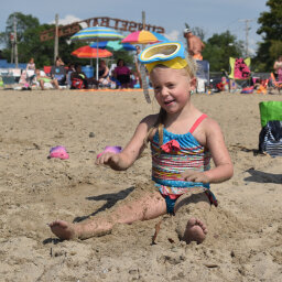 Girl playing in sand at Lake Erie beach