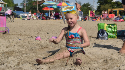 Girl playing in sand at Lake Erie beach