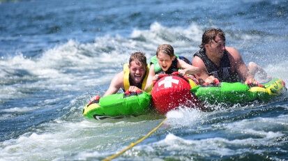 Three kids tubing on Chautauqua Lake