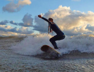 Surfer hitting the waves on the lake.