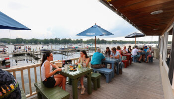 People dining outside at the Village Casino in Bemus Point